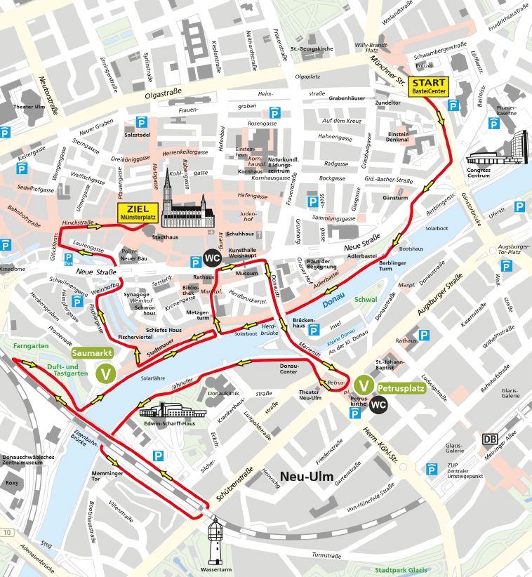 A detailed city map highlighting a route with arrows leading to M nsterplatz marked as the destination, showing streets, landmarks, parking areas, and public facilities in a central urban area near the Donau river. Beschreibung von KI generiert